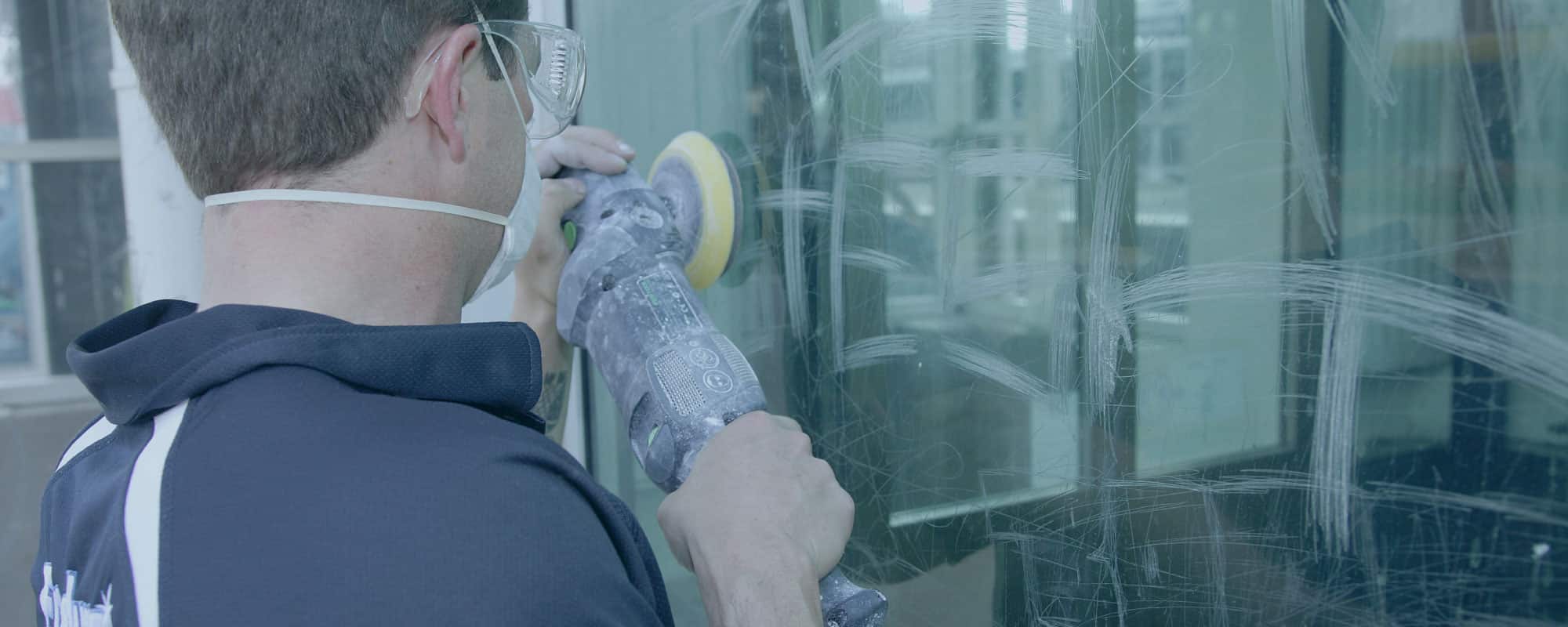 man removing scratches from glass